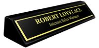 Black Metal Name Plate with Gold Engraving and Shiny Gold Border on an 8" Black Piano Finish Deskplate